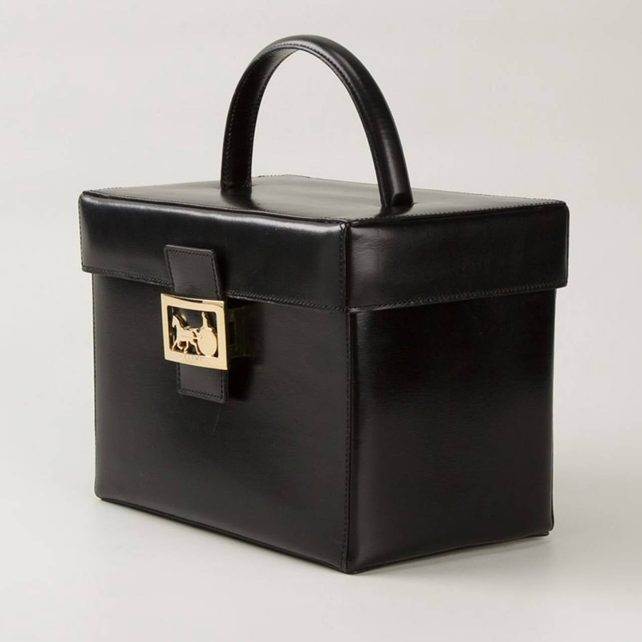 This classic Black Leather vanity case from Céline features a foldover top with clasp closure, a flat top handle, Gold-tone hardware, an internal zipped pocket, an internal mirror and an internal logo patch.

Measurements: Depth: 14cm, Height: