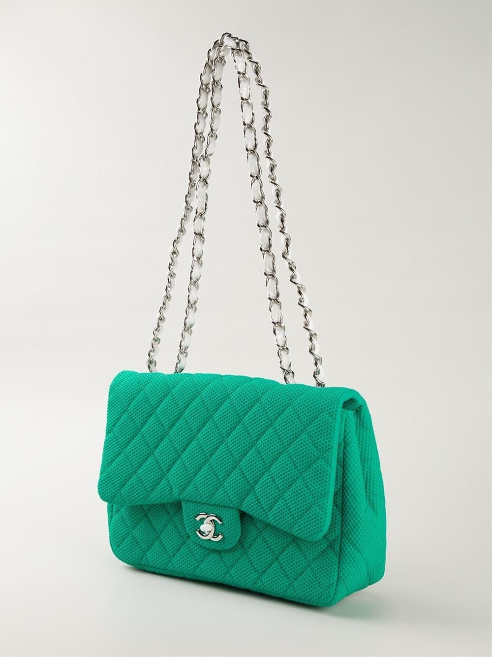 This green cotton 'Classic Flap' bag from Chanel features a foldover top, a quilted effect, an internal slip pocket, an internal zipped pocket, an internal logo patch, a back slip pocket, CC turn-lock closure and a double chain shoulder