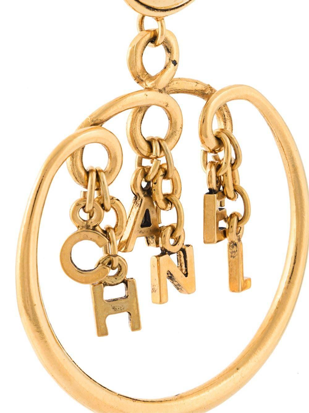 Gold-tone metal logo charm hoop clip-on earrings.

Colour: Gold-tone

Material: Metal (Other) 100%

Measurements: Circumference: 12cm

Condition: 8.5 out of 10
Excellent