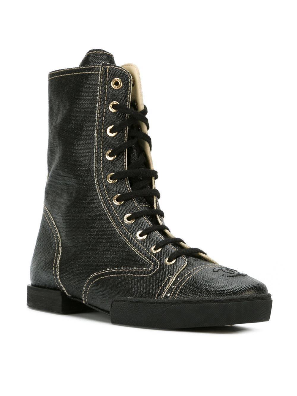 Black cotton lace-up boots featuring a round toe, an embossed logo, a lace-up front fastening, a stitch detail, a flat rubber sole and a leather inner. 

Colour: Black

Material: Cotton 100%

Measurements: Wedge: 2.5cm, Height: 19cm, Heel: 4cm