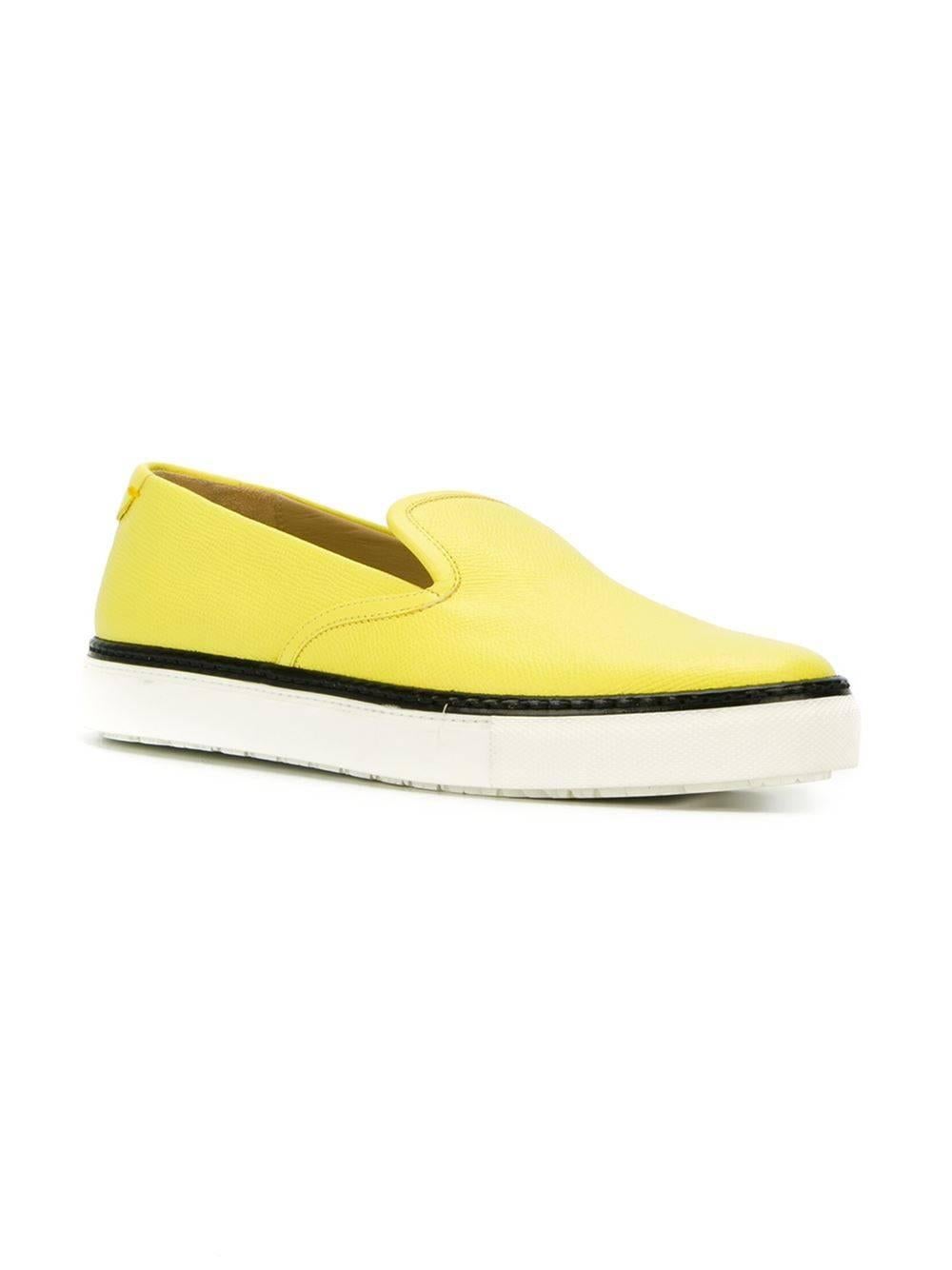 Yellow leather slip-on sneakers featuring an almond toe, a brand embossed insole, a contrast piped trim, a back embossed logo stamp and a flat rubber sole.

Colour: Yellow

Material: Leather 100%

Measurements: Wedge: 3.2cm, Size: EU