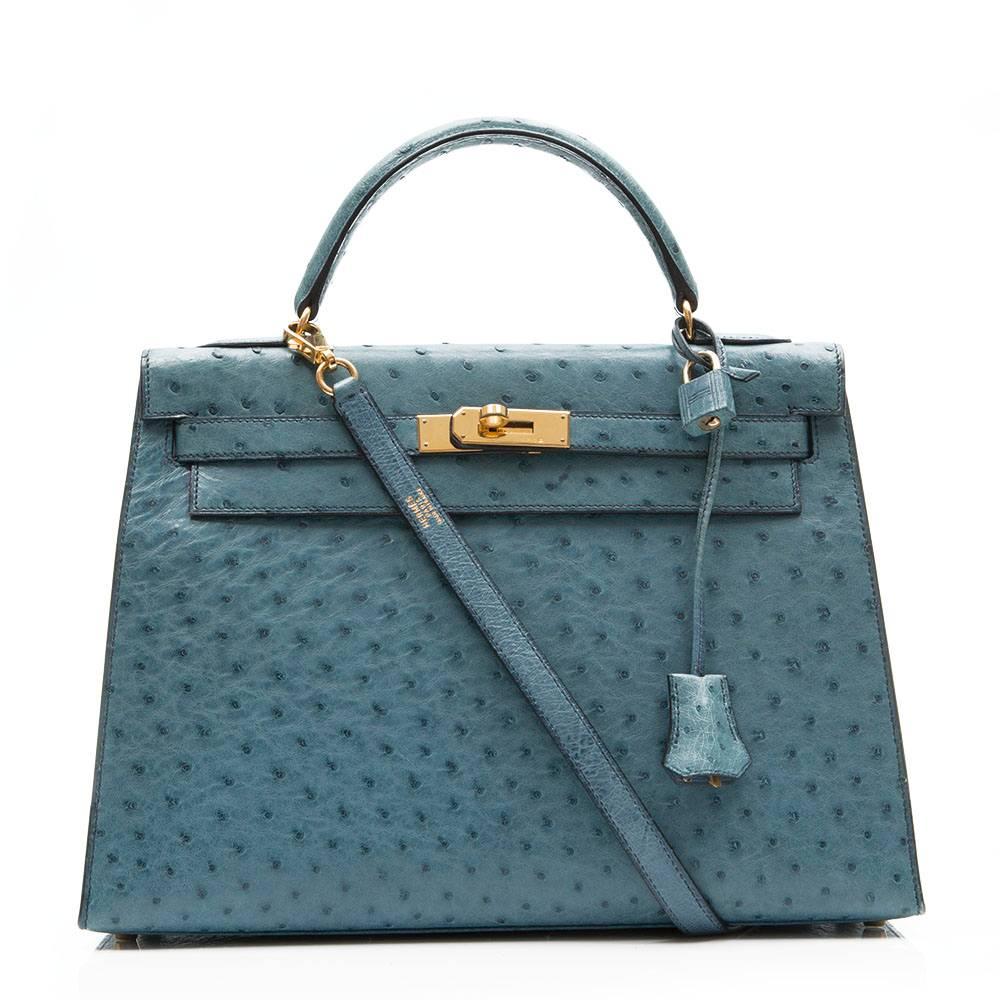 Hermes vintage Blue Jean 32cm Kelly bag in ostrich leather featuring gold plated hardware.The interior of the bag is lined in matching goat leather with one zipped and two open pockets. 

This bag comes with its strap, lock and key, protective