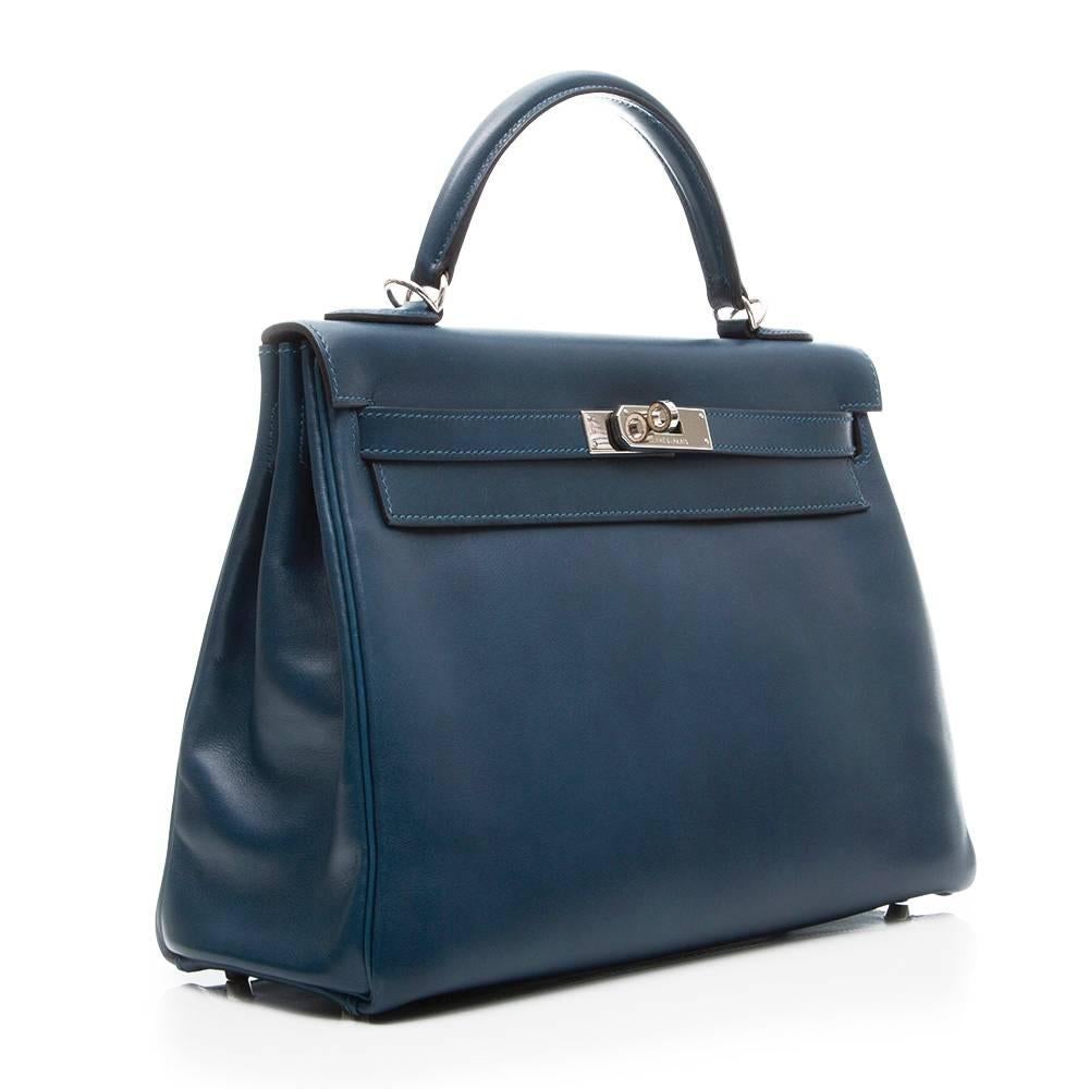 Hermes 32cm Kelly bag in 'Blue de Malte' leather, featuring palladium hardware, top handle and detachable strap. This bag has a matching goatskin leather interior with one zipped pocket and two open pockets. The bag comes with its detachable strap