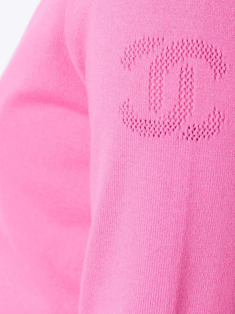 Pink zipped cardigan from Chanel featuring a scoop neck, a front zip fastening, three-quarter length sleeves, a contrast piped trim, two front pockets and a straight hem.

Colour: Pink

Material: 24% Polyester, 86% Viscose

Measurements: