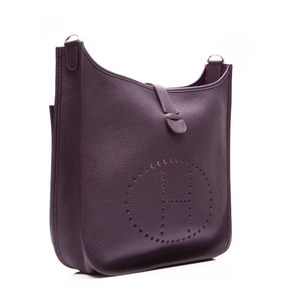 Raisin Clemence leather 'Evelyne TPM' shoulder bag featuring a perforated 'H' detail, a detachable and adjustable shoulder strap, a strap closure, a back pocket, palladium hardware and a suede lining.

Colour: Raisin/ purple

Material: Clemence