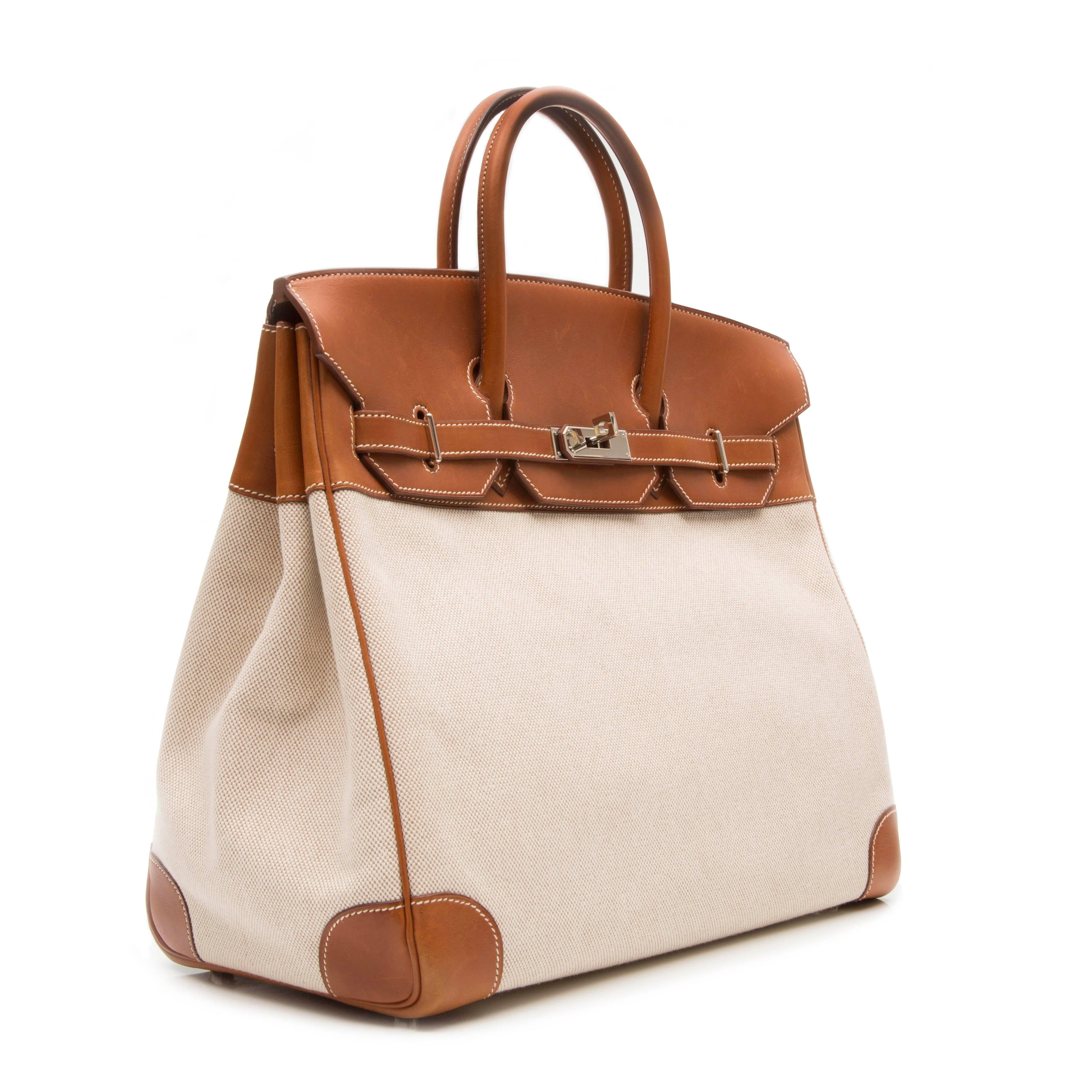 Brown cotton and leather 'Birkin' tote featuring a foldover top, a round top handle, a silver-tone twist lock fastening, stitching details, a hanging luggage tag, an internal zipped pocket and an internal patch pocket. 

Colour: Brown

Material: