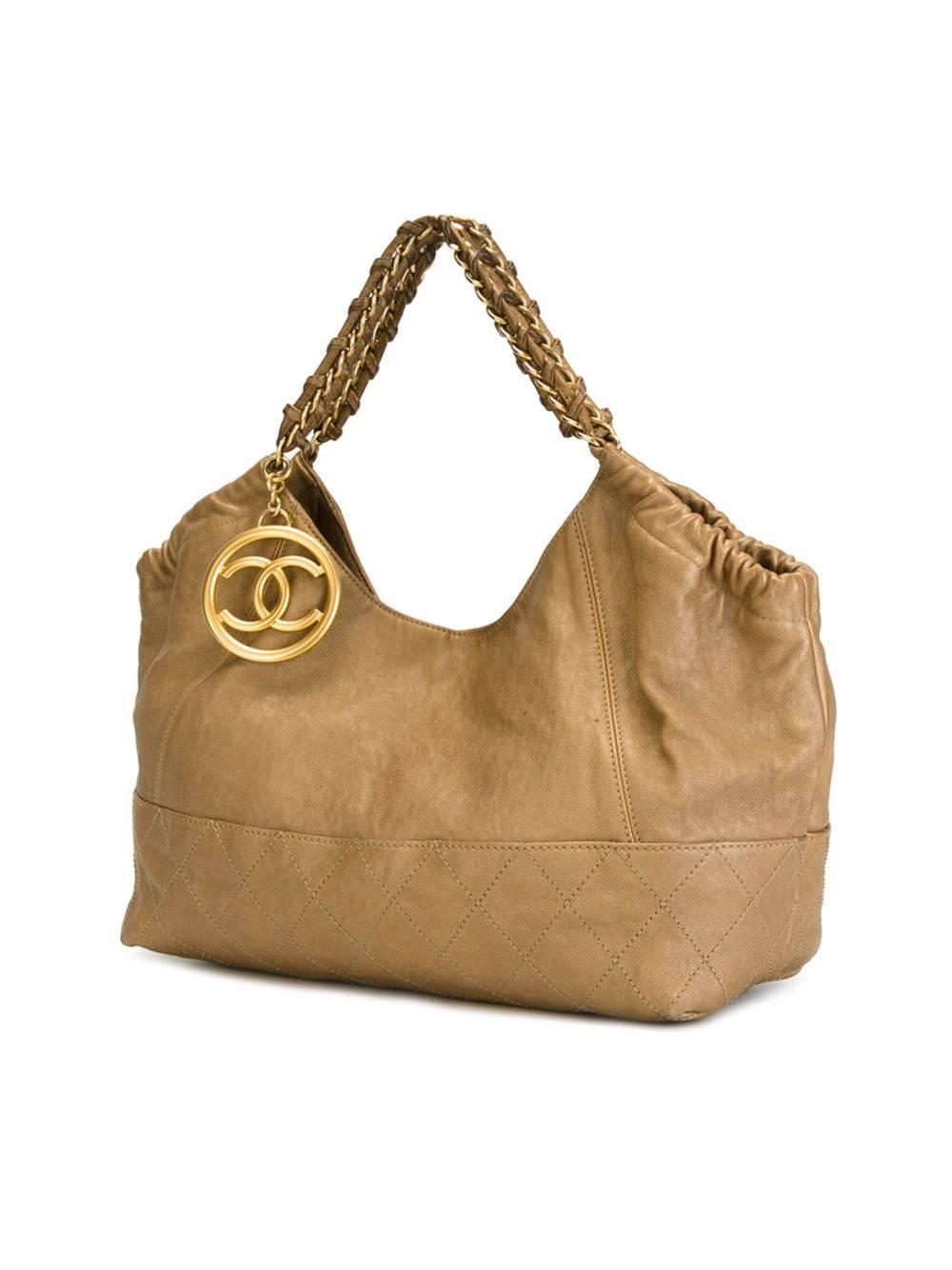 Gold-tone leather slouchy tote featuring braided handles, a gold-tone logo plaque, stitching details, an internal zipped pocket and an internal logo patch.

Colour: Gold-tone

Material: Leather 100% / Metal 100%

Measurements: W: 46cm, H: