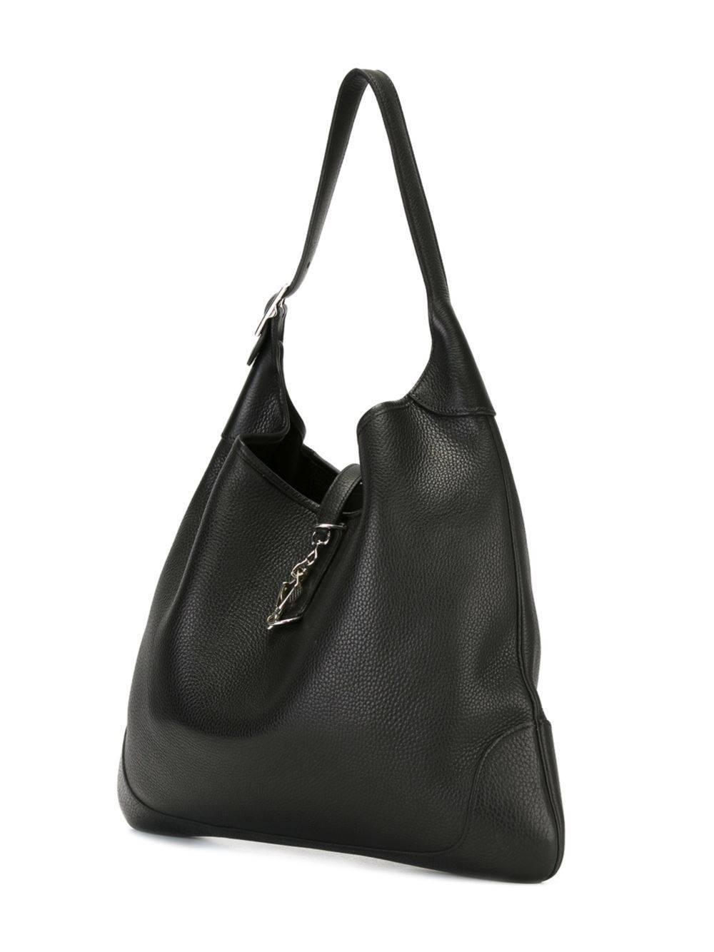 Black leather slouchy hobo tote from Hermès Vintage featuring a pebbled leather texture, a strap closure, silver-tone hardware, an internal zipped pocket and an adjustable top handle. This bag comes with its original dust bag.

Colour: