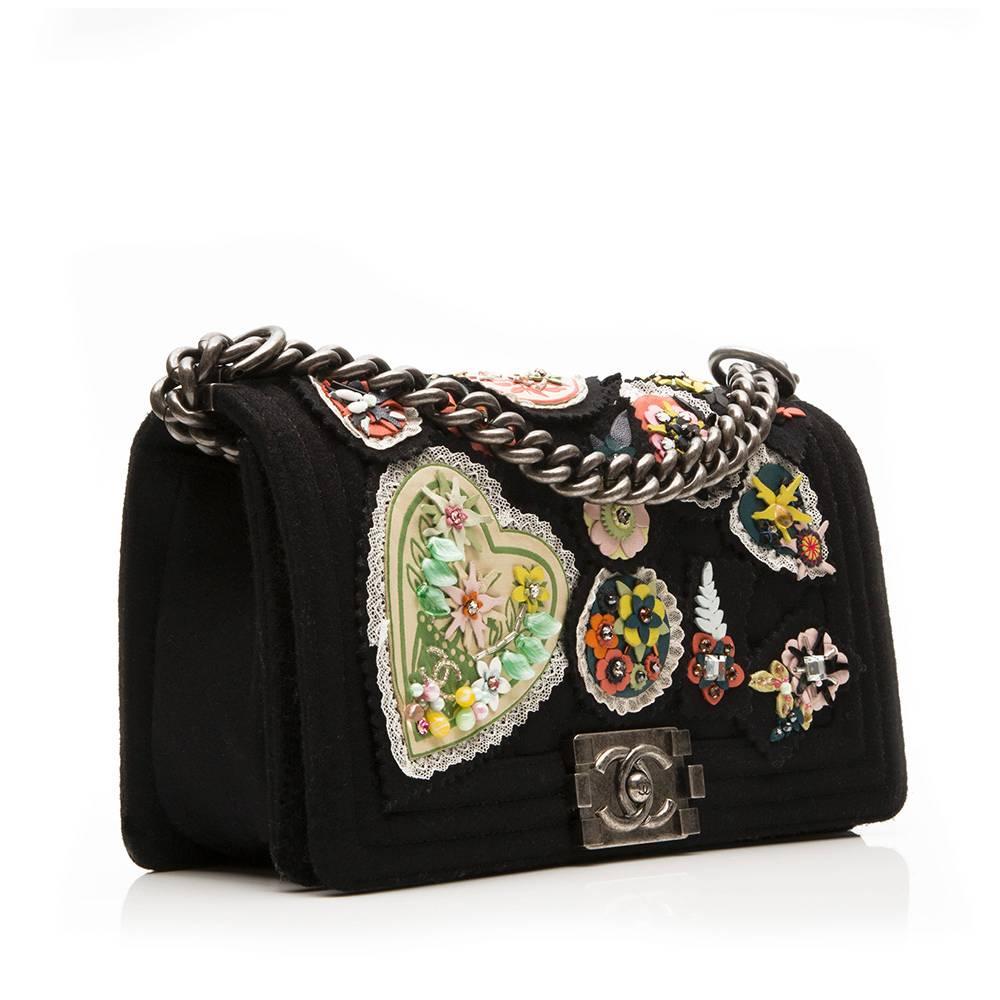 Chanel Boy Bag in felt featuring beaded, leather and lace badge embellishment and ruthenium hardware. The interior of the bag is lined in black fabric and has one open pocket.

Colour: black

Material: felt, leather

Measurements: W: 25cm H: