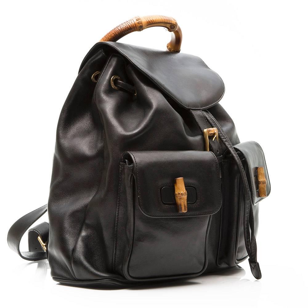 Black leather Gucci backpack featuring bamboo handles. this backback has drawstring closure and a top flap with a buckle. The interior is lined with black fabric and has one zipped pocket.

Colour: Black

Material: Leather,