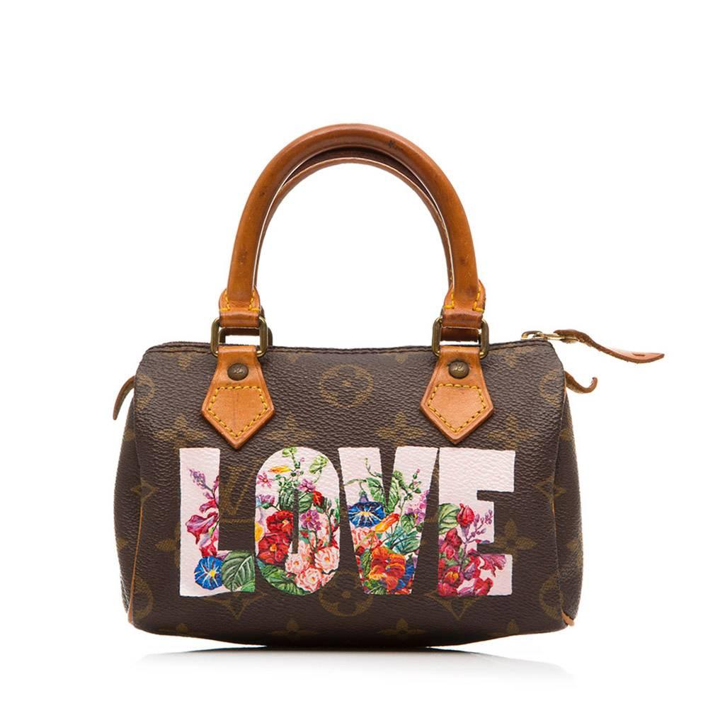 The Louis Vuitton Nano Speedy handbag is irresistibly sweet in its miniature form. This version, in the utterly iconic Monogram canvas, is lifted to further levels of desirability with a beautifully hand-painted facade, adorned in “Love”, and a
