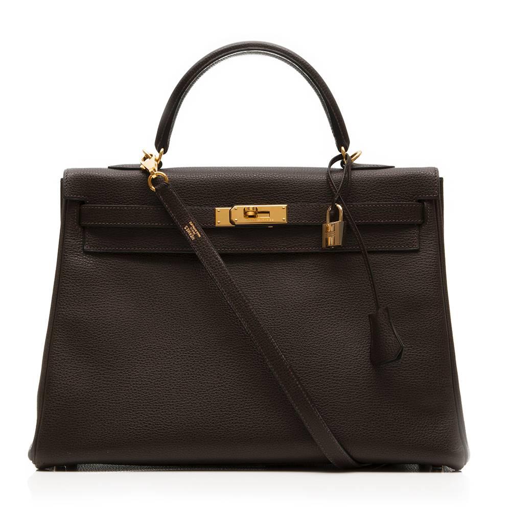 In an enduringly elegant colourway, this Hermès Kelly handbag exudes the same classic femininity as its iconic muse, Princess Grace Kelly. In the deep brown shade of ​brown , and accented with gold-tone hardware, it is crafted in Fjord leather, a
