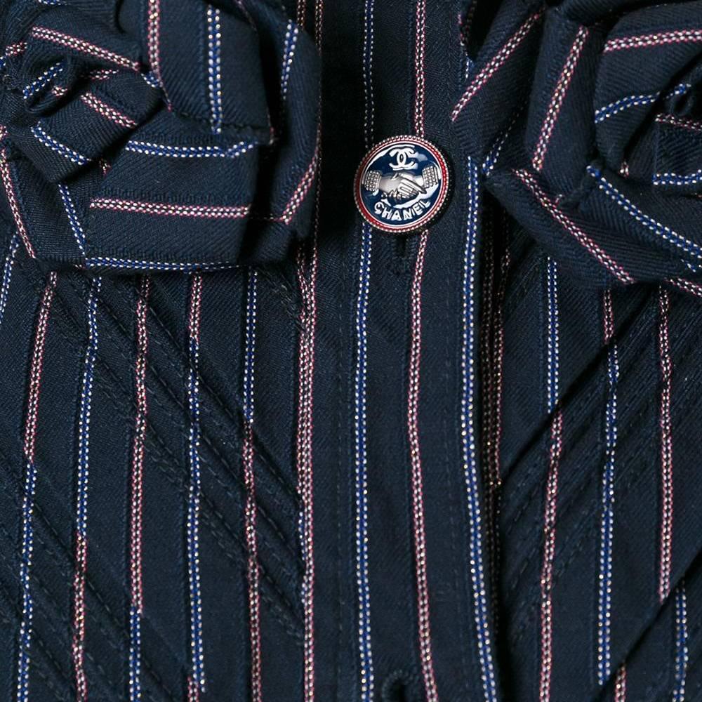 This lightweight vintage Chanel jacket makes an utterly Parisian statement. Featuring metallic stripes in red and navy, offset with tricolore buttons embossed with the Chanel monogram. Flatteringly finished with a cropped, cinched shape, with