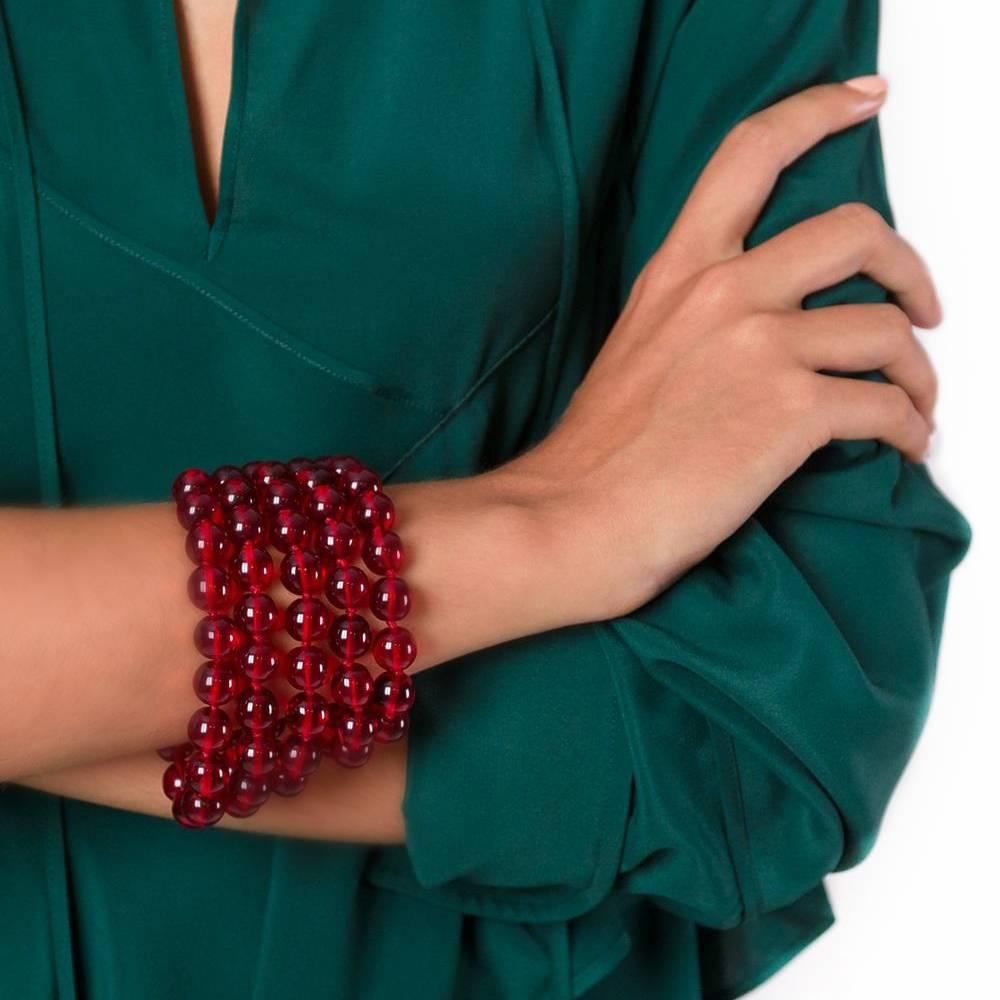 Uplift a day-to-night look in an instant with this opulent design from Chanel. This vintage Chanel bracelet features three rows of red glass beads, offset with gold-tone finishings. Its chain closure features a subtle Chanel logo plaque.