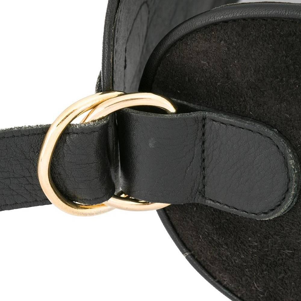 Sharply cut to a wide silhouette that accentuates the waist, this vintage Yves Saint Laurent belt is crafted from black suede whimsically studded with gold-tone baubles. The belt is lined and trimmed in black leather. A rare item designed in the