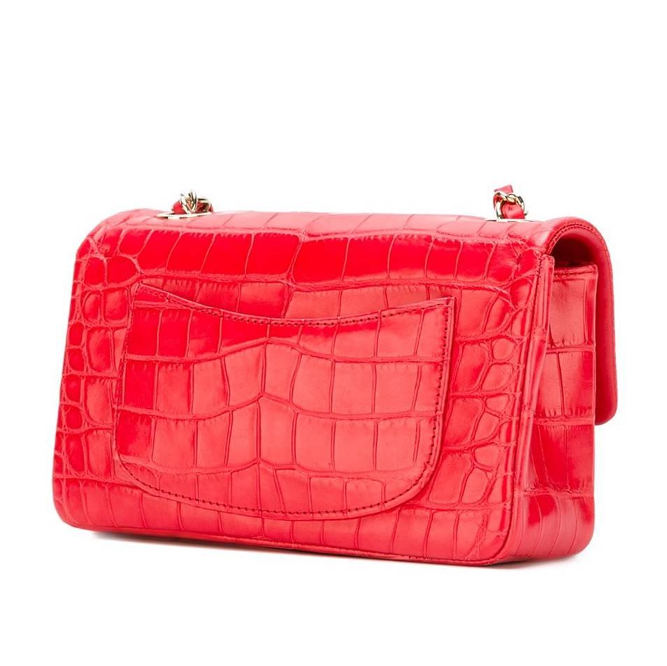 Brighten up your wardrobe with this vivacious rendition of Chanel's small Classic Flap shoulder bag. It is crafted in a beautifully patterned matte alligator skin in a playfully Parisian shade of bright red, offset by silver-toned hardware.