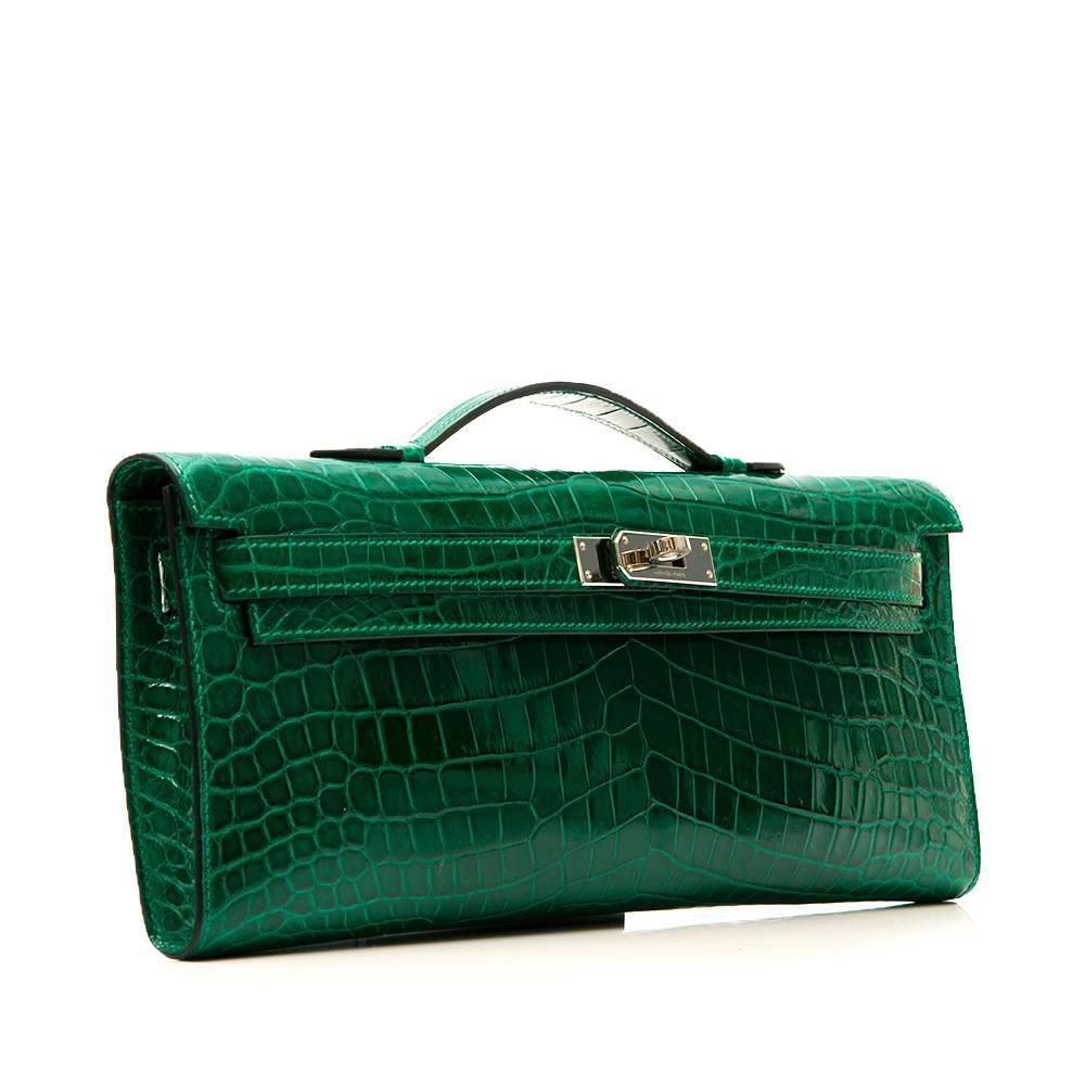 This exotic Kelly Cut has tonal stitching, front straps with toggle closure and a top flat handle. The interior is lined in signatureEmerald Green chèvre leather and features an open wall pocket.

This bag comes with its original dustbag,