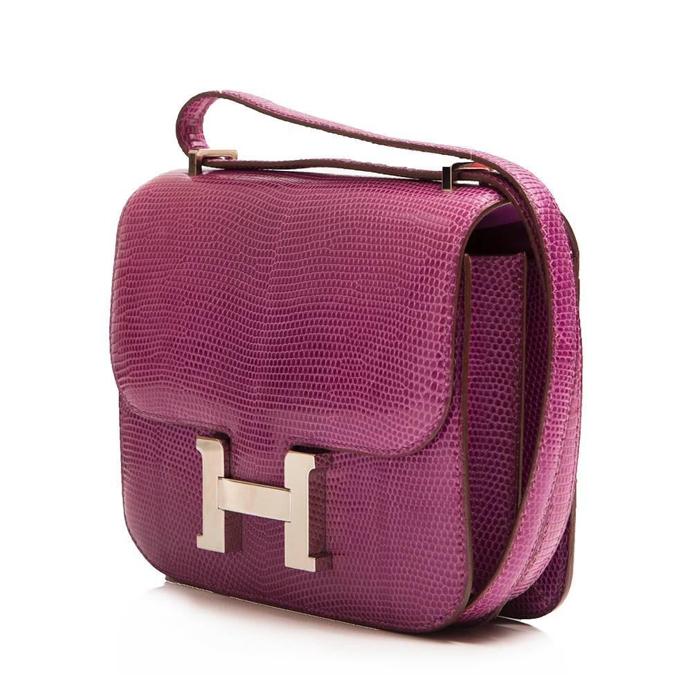 A striking rendition of Hermès’ iconic Constance Mini bag, crafted from a lizard skin in Anemone purple and finished with gleaming palladium hardware. Lizard skin is rarely used by Hermès anymore due its scarcity, but is a spectacular finish with