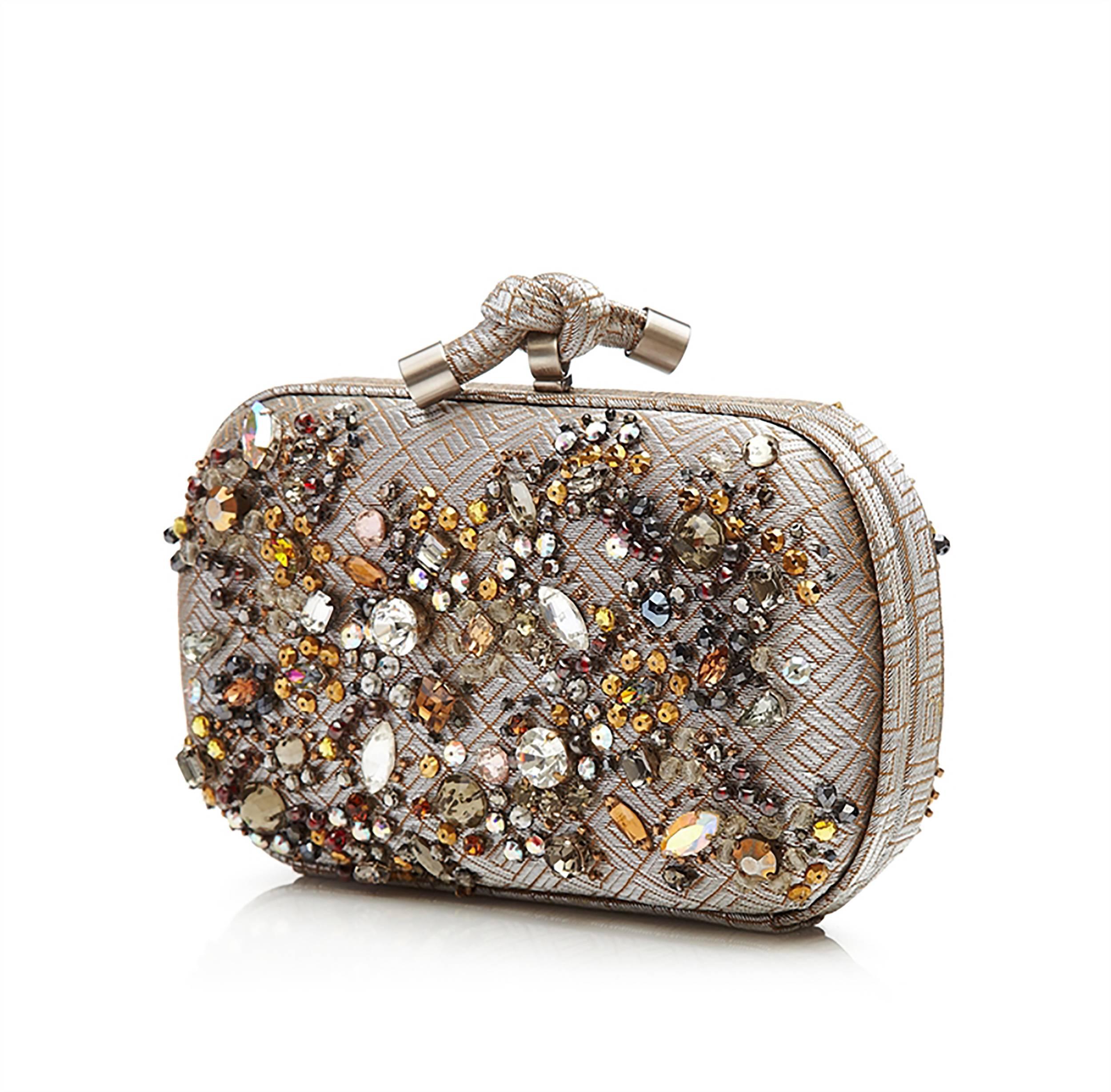 A highly rare and limited edition version of Bottega Veneta's Knot clutch bag. Finished to glittering perfection, its hard-shell exterior features a subtly patterned lurex fabric hand embroidered with heaps of sparkling crystals. It opens with