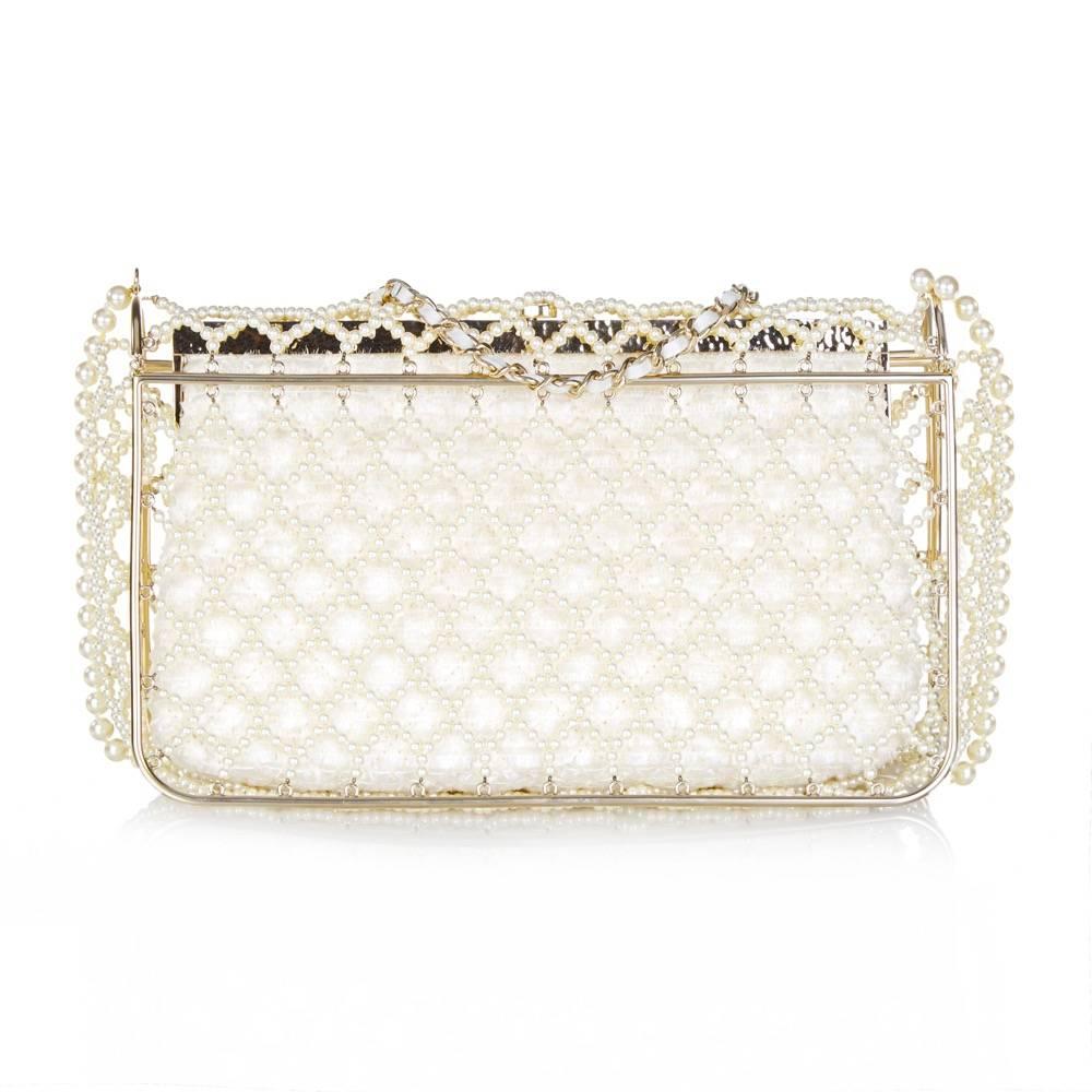 An enchanting edition of the Chanel Classic Flap bag, crafted from a cage of fantasy pearls. Inside the cage is a second clutch, cut from a lustrous, fringed and quilted textile. It is lined with ivory satin, and offset with pale gold-tone hardware.