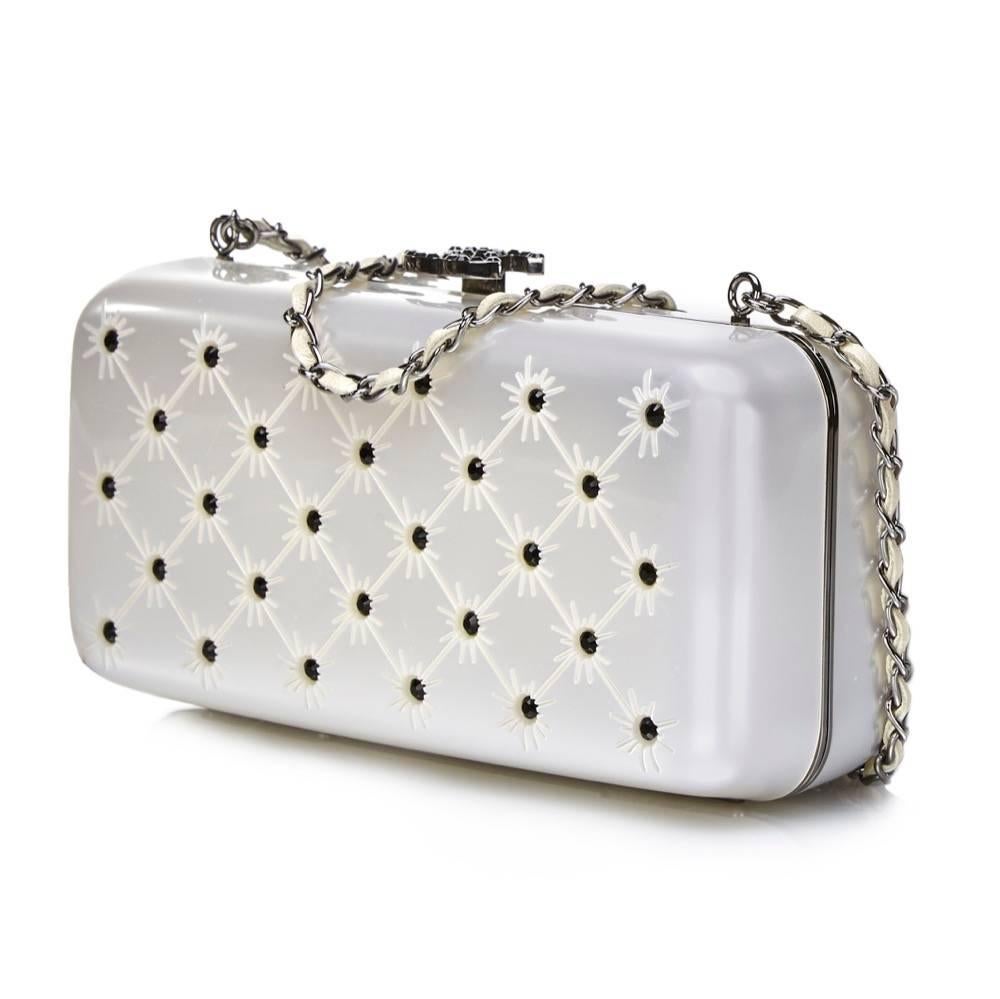 Add a subtle glimmer to your outfit with this minaudière from Chanel. Its silver hard casing is offset with black crystal strass and dark silver-tone metal. It unfastens with a Chanel monogram push clasp, also inlaid with crystals. The metallic