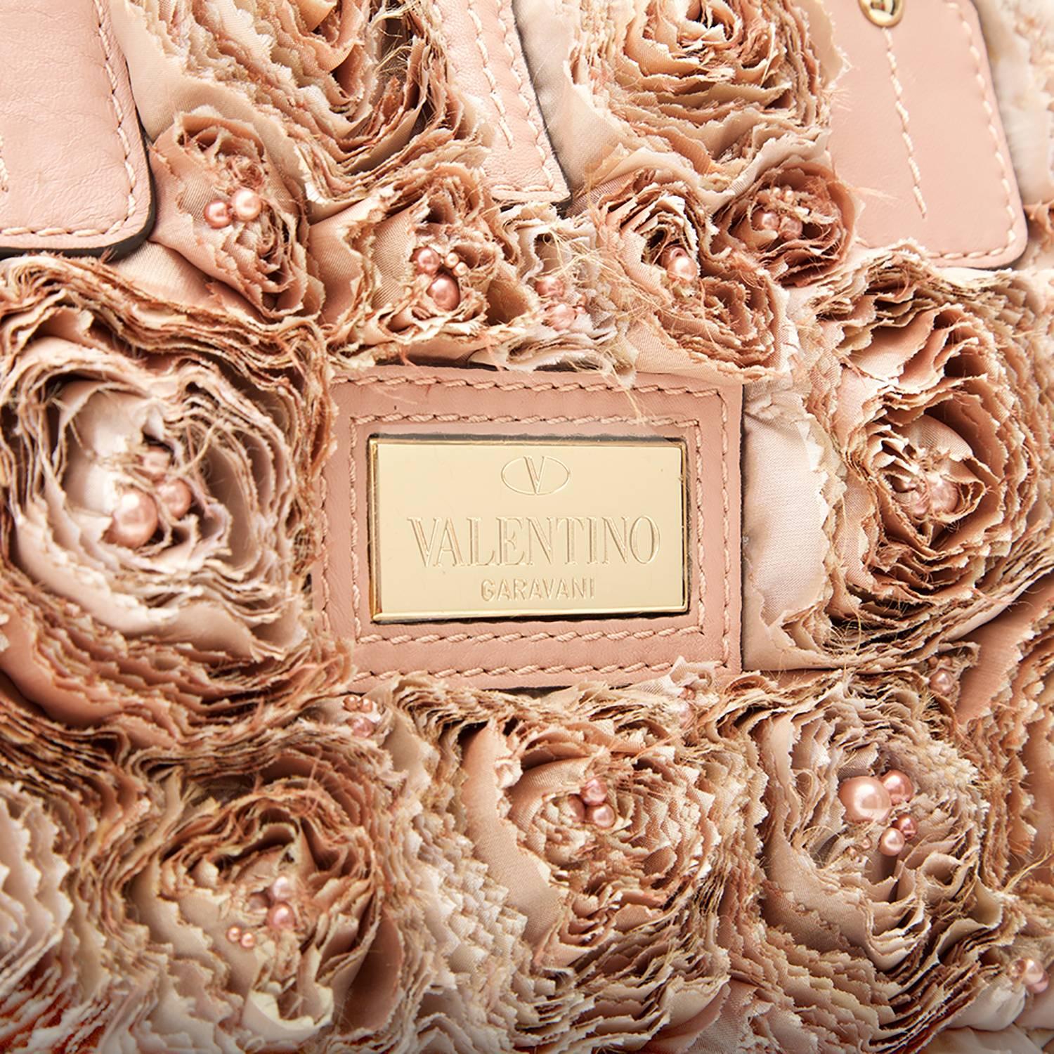 Valentino’s Buisson Rose tote bag is covered in an array of flowers. Crafted from shredded silk, beads and calfskin in muted blush tones, and featuring a central logo plaque in gold-tone hardware. Its spacious interior is lined in a tonal silk and