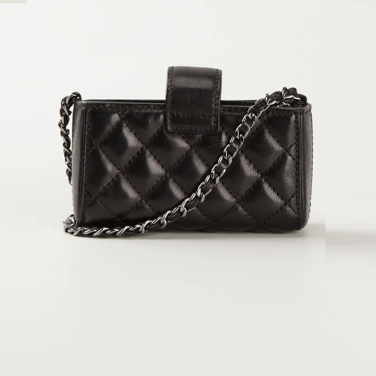 This small leather clutch from Chanel features a foldover top with snap closure, a quilted effect, a chain and leather strap, a logo to the outside, and interior zipped compartment and an internal logo stamp.

Measurements: height: 6 cm, width: 13