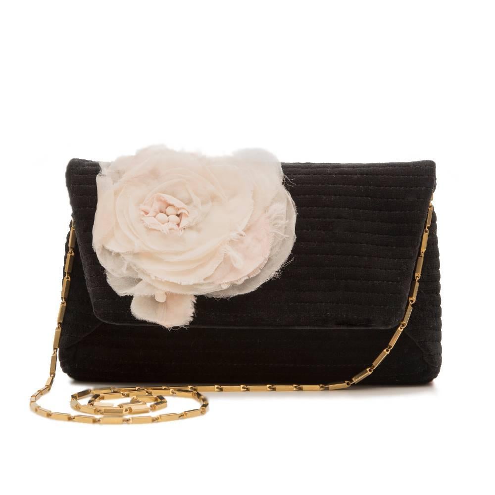 Lanvin's black flower clutch denotes classic Parisian elegance. It's crafted in Italy and features a frayed muslin flower detail for a flamboyantly feminine finish. The black silk and cotton blend clutch also has a gold-tone chain strap, a front