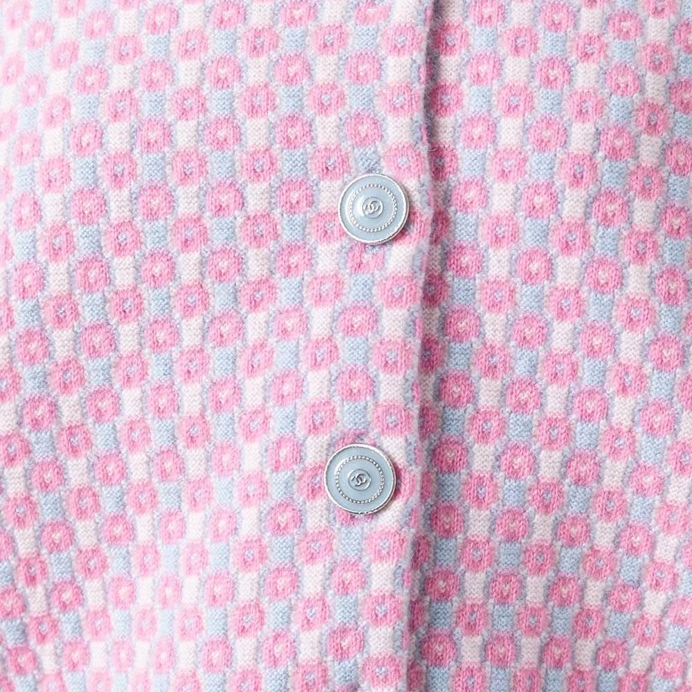 An utterly feminine confection, this Chanel cardigan is spun from cashmere in a pastel colourway. It is finished with sparkling, pale blue buttons detailed with monograms. The cardigan has a small fit, finished with pink ribbed banding along the
