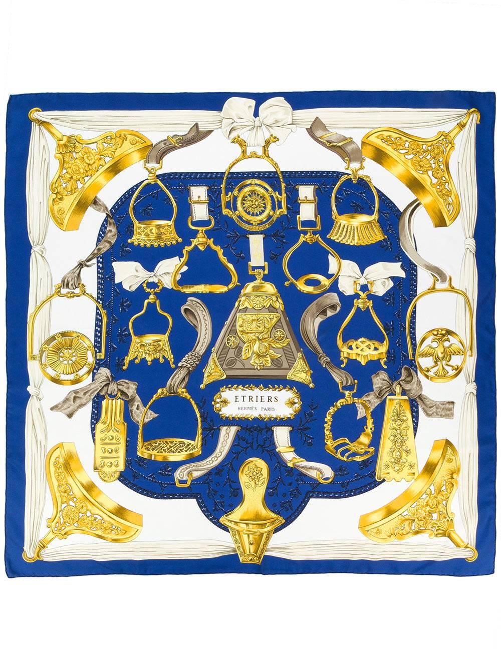 This beautiful blue silk Etriers scarf from Hermès Vintage features a golden stirrup print with a blue border. Perfectly adds a sophisticated pop of colour to your look. 

Colour: Blue/ Gold/ White

Material: 100% Silk

Measurements: 88cm x 86cm