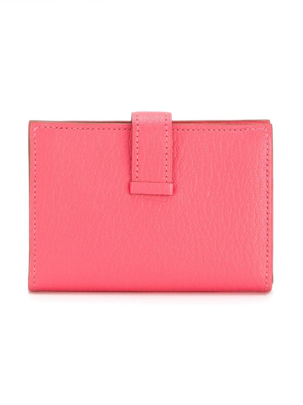 In vivid Rose Jaipur, this delicate Bearn mini wallet is made from Epsom leather. Featuring a single snap button pocket, a logo stamped pair of card slots and a strap fastening with the brands signature 'H' in silver tone metal.

This item comes