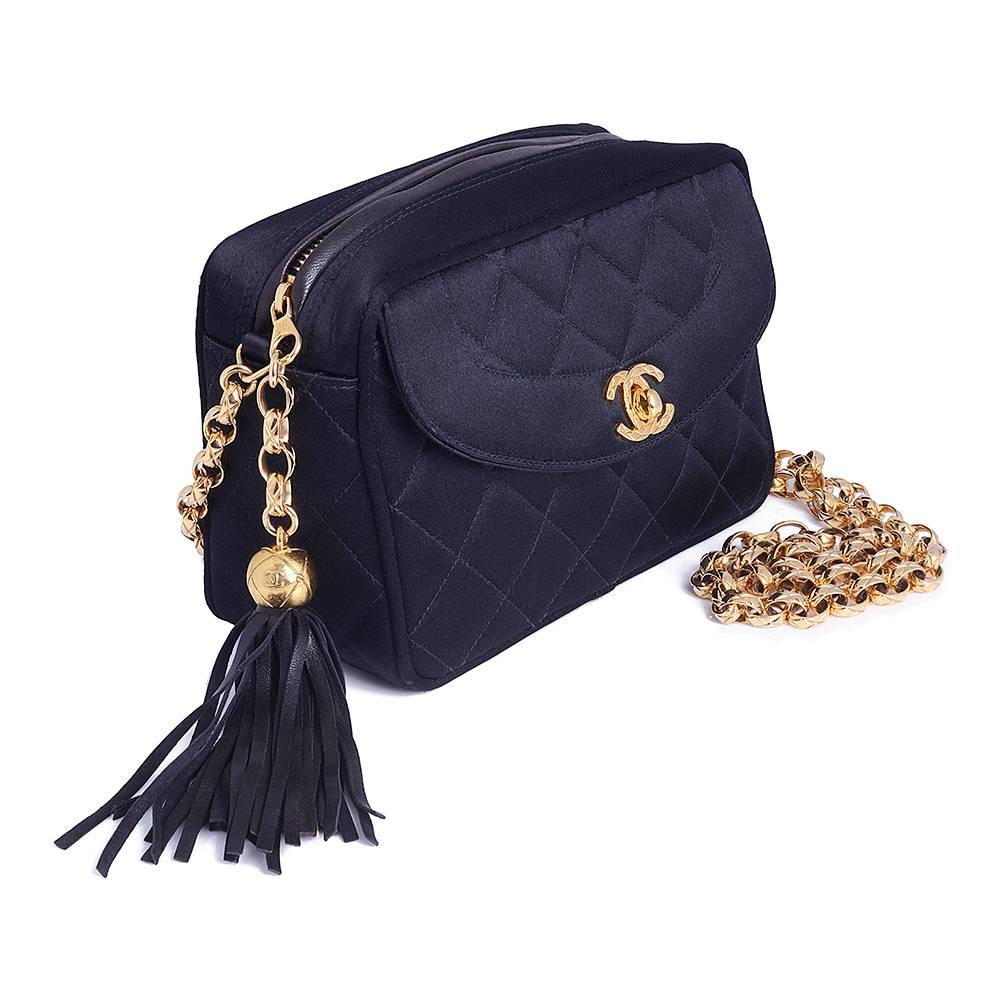 In black, this sweet satin box bag features a chain shoulder strap, and interior compartment for all of your essentials. Adorned with an internal logo plaque, gold-tone hardware and an interlocking CC turn lock.

Colour: Black

Composition: