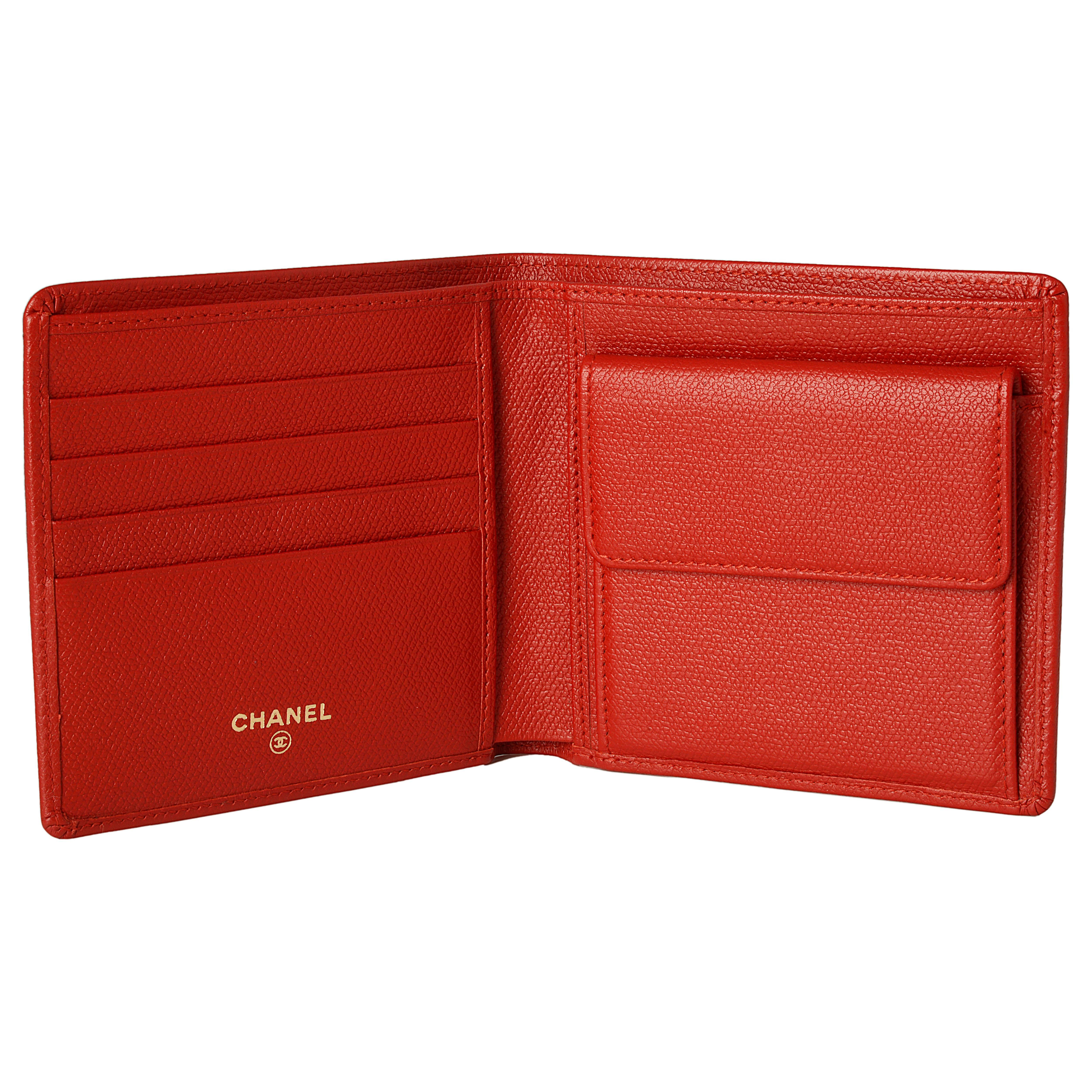 This Chanel wallet is expertly crafted from striking red leather. Featuring four card slots, a coin compartment and two main compartments this wallet is perfect for everyday use. The outside is adorned with the iconic interlocking 'C' logo in