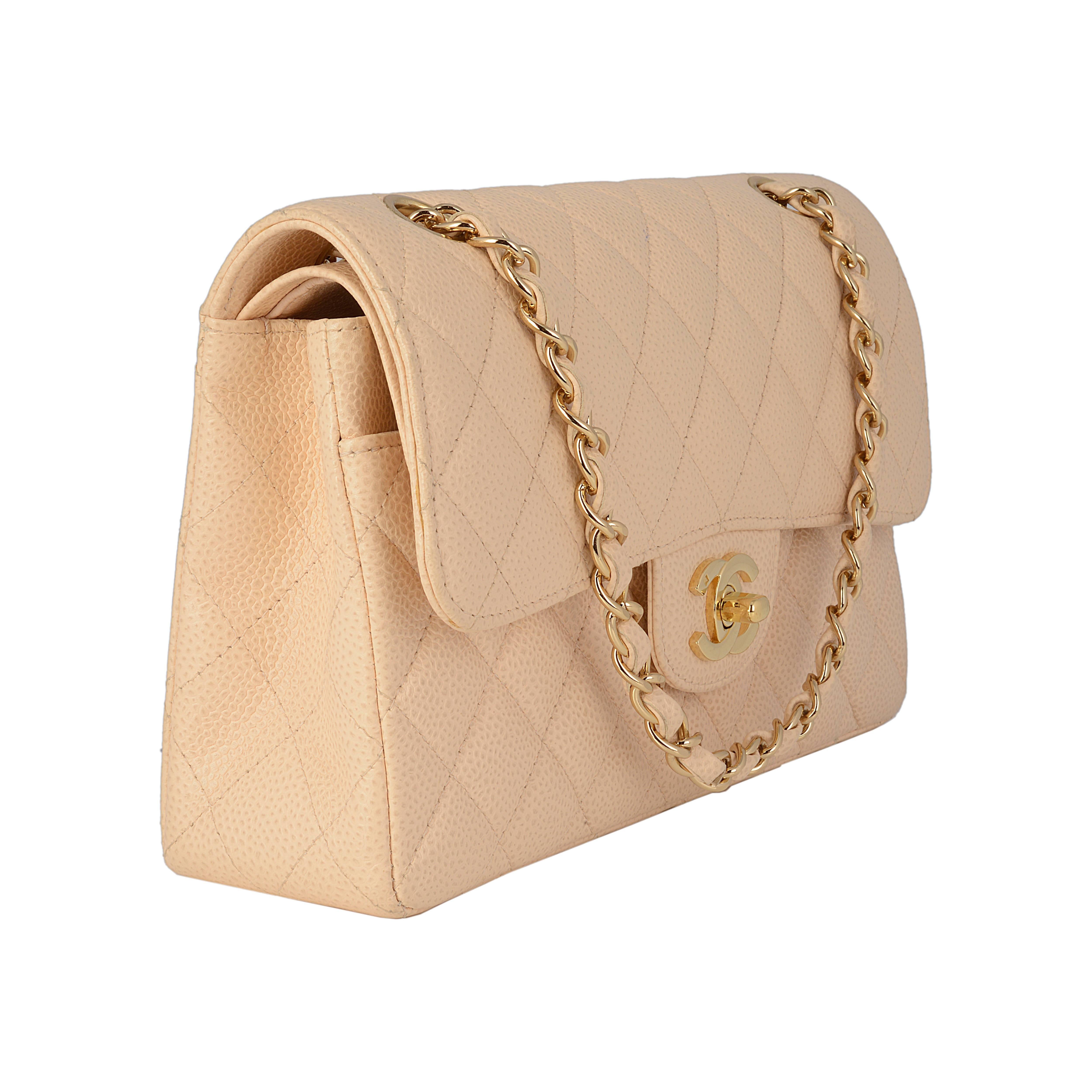 This timeless Chanel flap is crafted from durable quilted caviar leather and features a goldtone turnlock CC closure and double flap interior. The versatile leather strap chain can be worn on the shoulder or lengthened to wear with a longer drop.