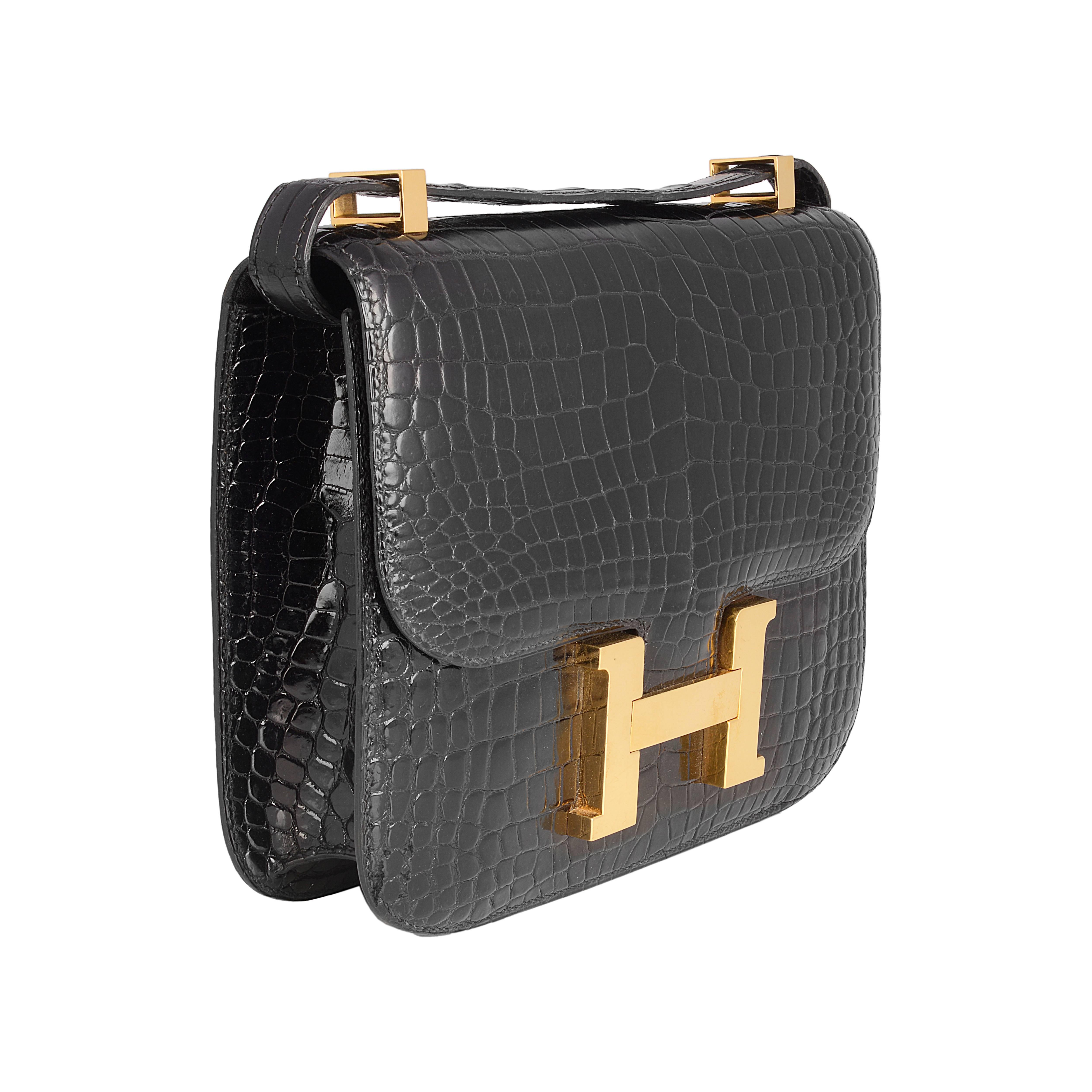 Crafted in the extremely rare crocodile skin, Porosus, this vintage edition of the Hermès Constance comes in an elegant black colour. The interior features two pockets, one zipped. Combined with the gold-tone large H hardware, this bag is a must
