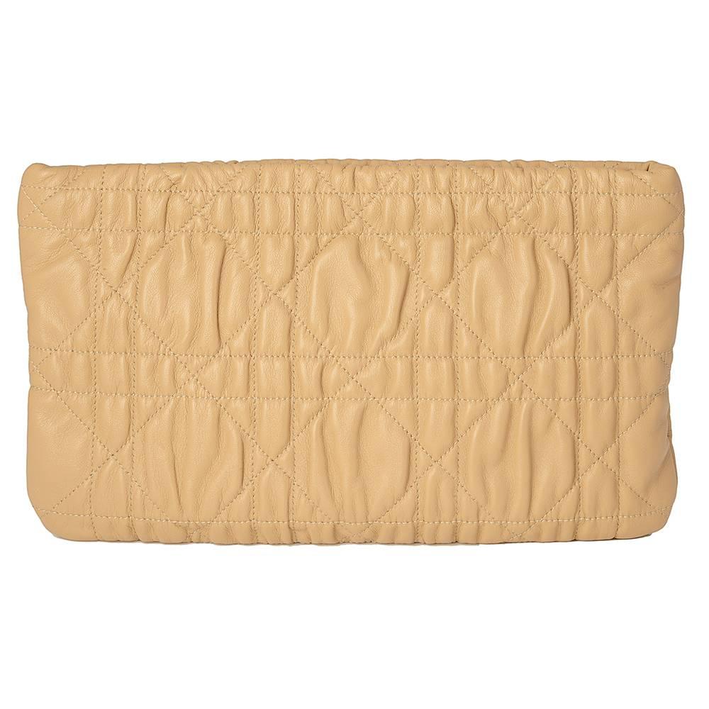 This Christian Dior envelope clutch bag is crafted from beautifully soft ruched beige leather and features a 3D satin rose design on the bottom corner, exuding the classic femininity known to the brand. Inside, the spacious main compartment features