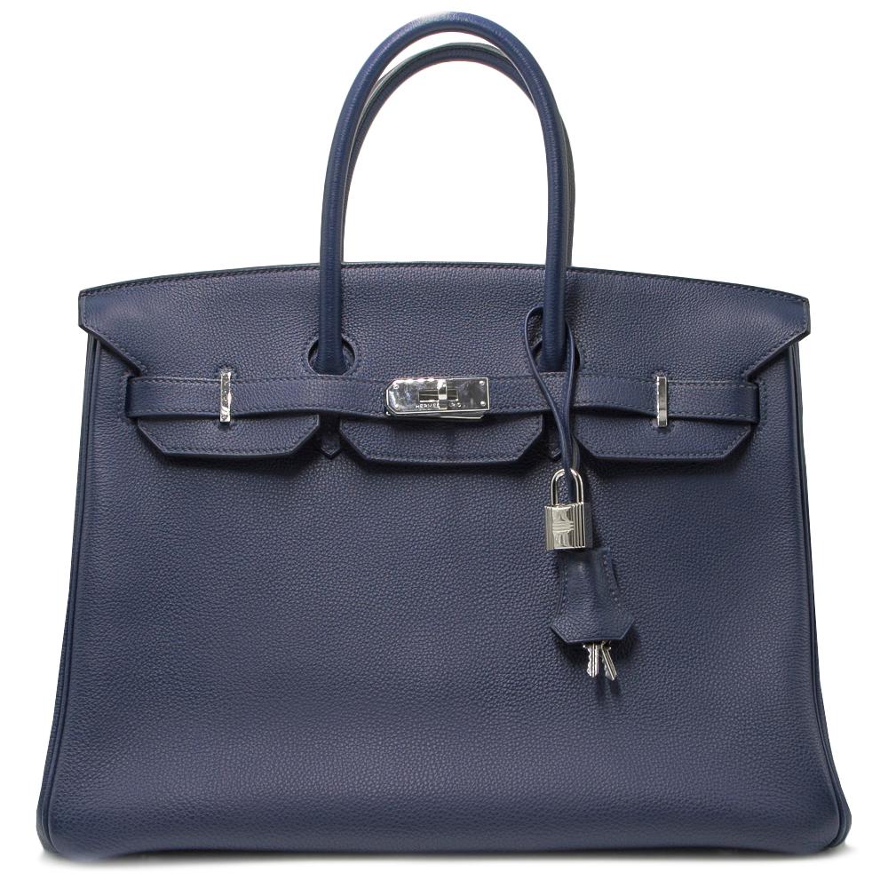 Invest in a very rare and limited edition piece with this Hermes Birkin, crafted in luscious Blue Nuit Togo Leather and lined with a matching goatskin leather, this spaciously sized bag features two interior pockets: one open and one zipped and is