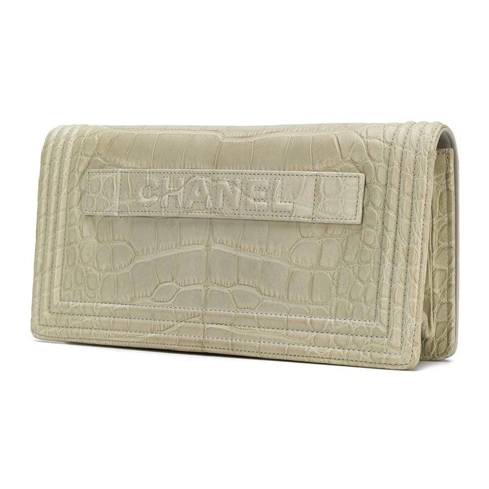 Crafted from beige crocodile leather, this stunning Chanel clutch bag features a foldover top with a silver-tone logo closure, a hand strap, an internal zipped pocket and embossed logo plaque.

This bag comes with a Chanel Care Guide and