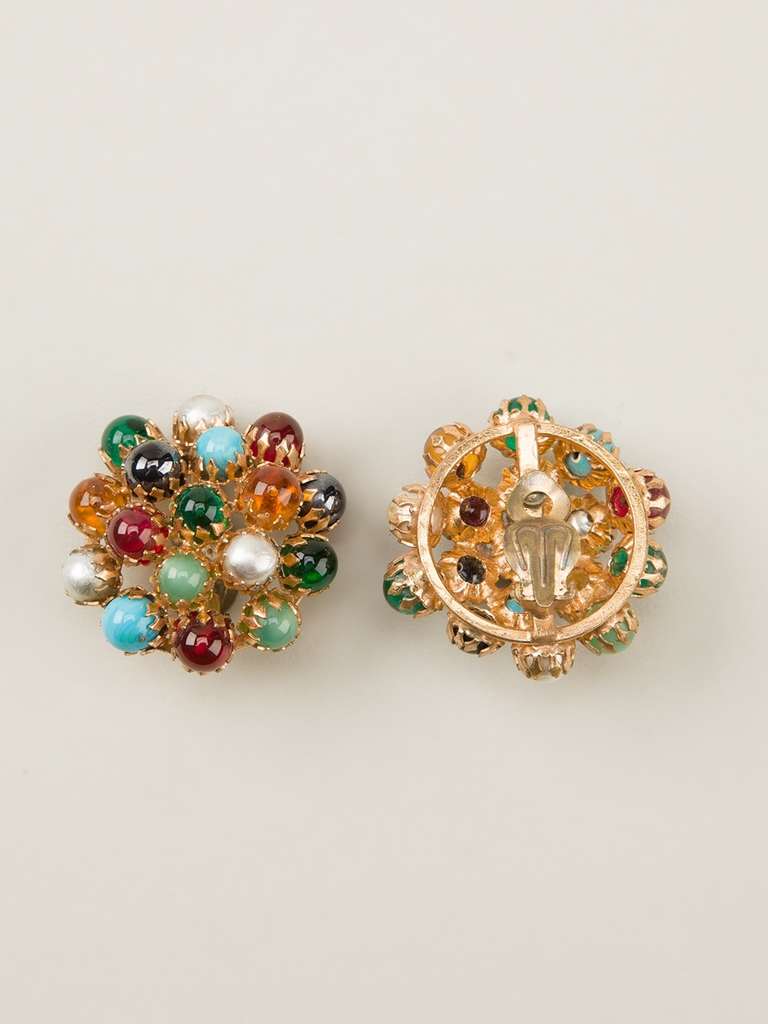 Gold-tone metal clip-on earrings from the 1940s with a colourful stone-embellished front.