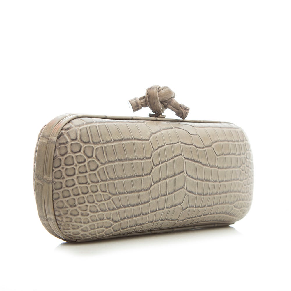 This beautiful clutch from Bottega Veneta features a grey croc leather body, accented with a logo detail clasp. The contrast lining is crafted in pure suede.

Material: Crocodile Leather

Colour: Grey
​
Condition: 9 out of 10
Excellent