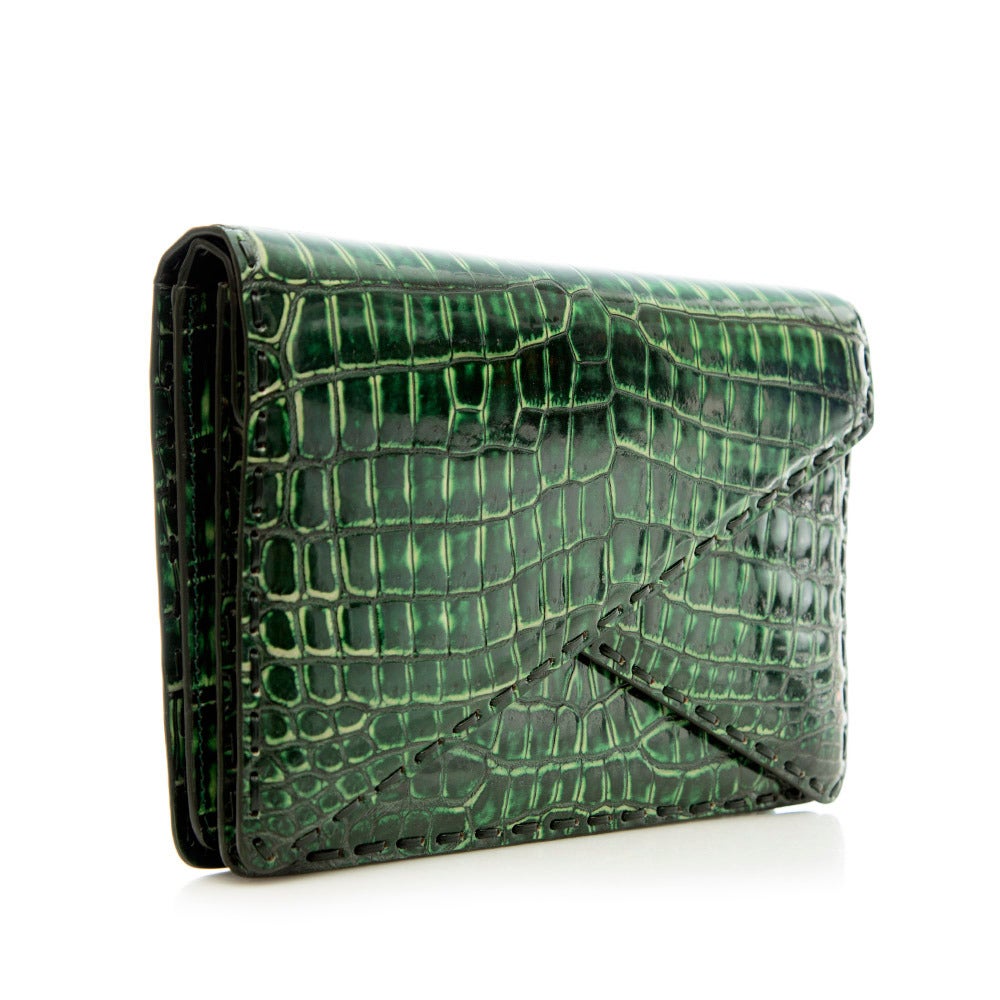 A disarmingly simple yet bold piece, this modified envelope clutch from Bottega Veneta is crafted in green croc leather and features a hand-stitched double flap. The interior is crafted in supple leather and suede.

Material: Crocodile leather