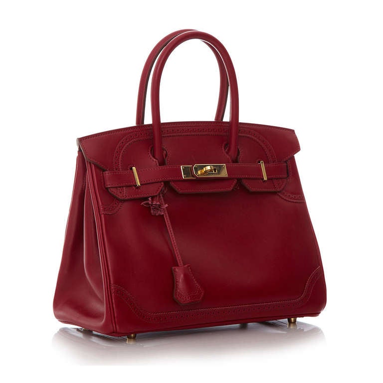 This rare Hermès Birkin Ghillies adds a youthful touch to the brand's classic style with its cut-out detailing and fiery colour. Accented with gold-plated hardware and featuring a twist-lock fastening, this reworked model is as unique as it