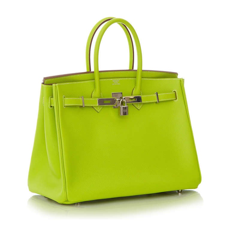 This Candy Birkin bag is an extremely rare limited from Hermès and is crafted in an eye-catching Kiwi Epsom Leather and accented with the brand's signature palladium hardware. Its interior is lined in a leather with a darker shade of green and