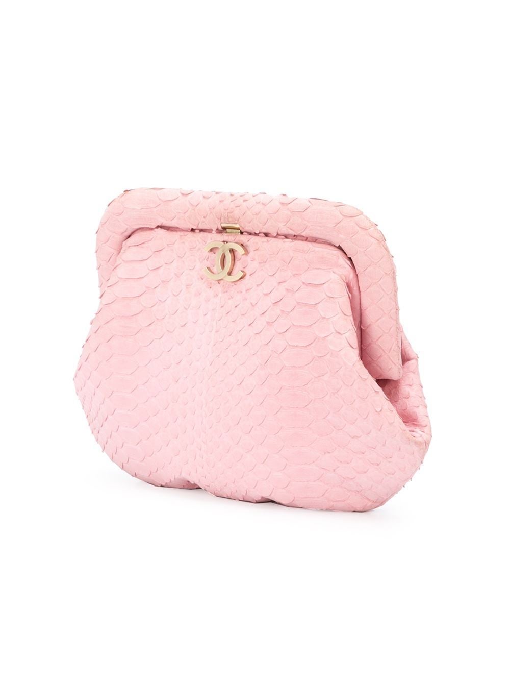 This pink python skin small embossed clutch from Chanel features a top clasp fastening, a gold-tone logo plaque and an internal logo plaque. 

Colour: Pink

Material: Python

Measurements: height: 19 centimetres, width: 25
