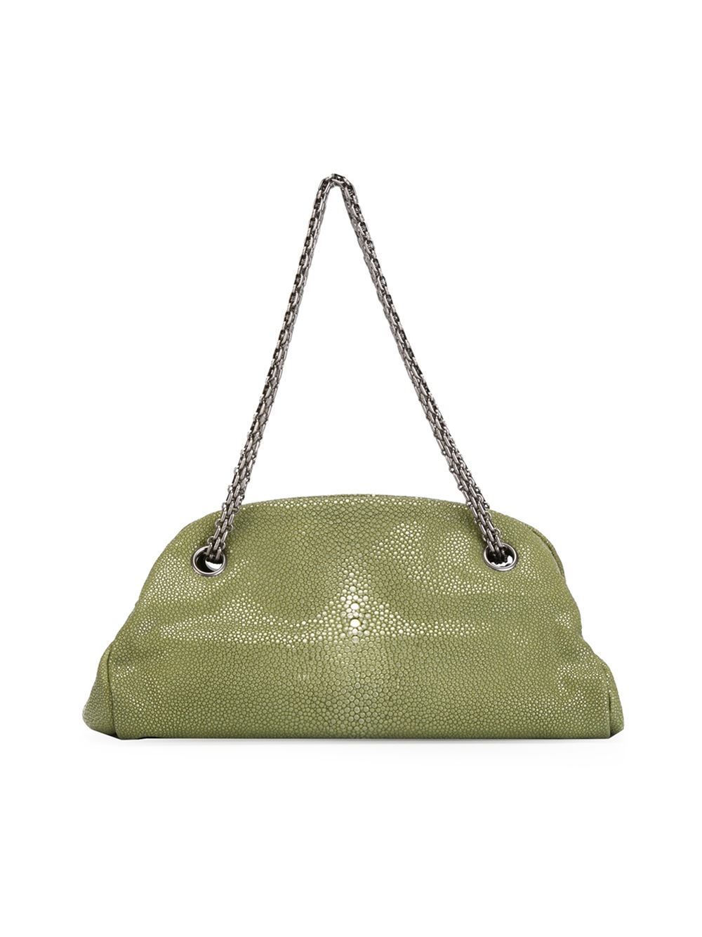 Green stingray half moon tote from Chanel features an open top design, a chain shoulder strap, a logo charm, an internal zipped pocket, an internal logo stamp and multiple interior compartments. Please note that vintage items are not new and