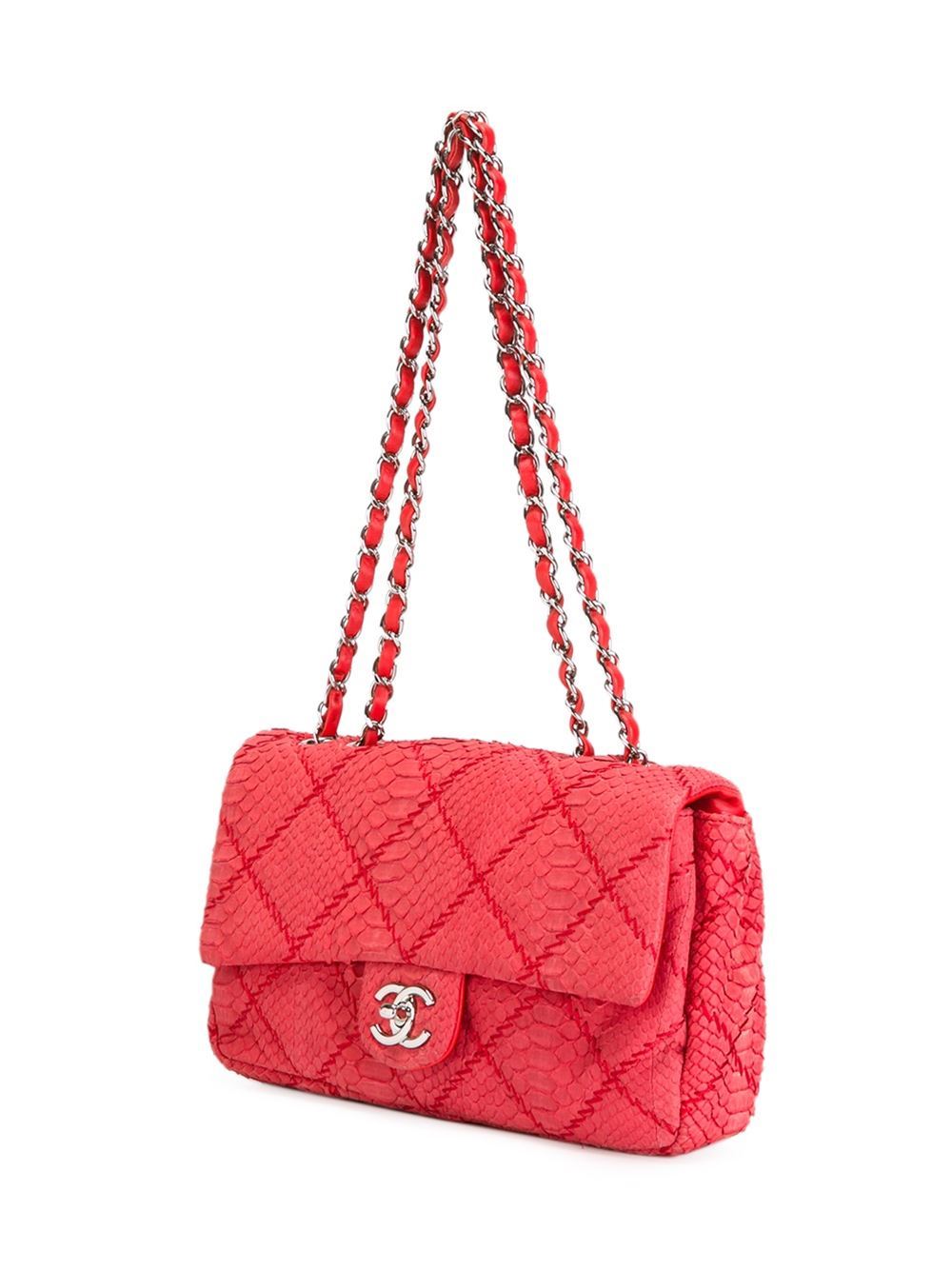 This red python skin flap shoulder bag from Chanel features a fold-over top with twist-lock closure, a silver-tone CC logo plaque, a quilted effect, a chain and leather strap, a back slip pocket, an internal zipped pocket, an internal slip pocket