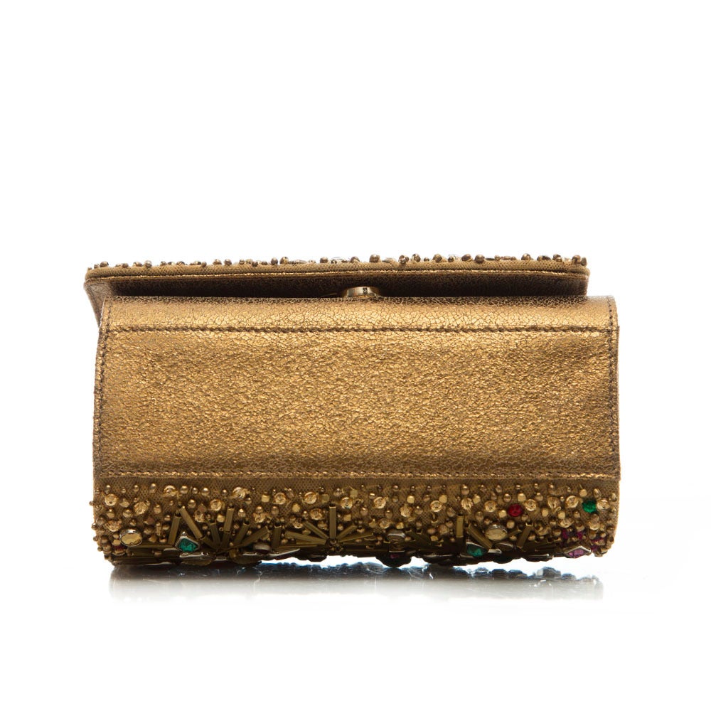 This box shoulder bag from Marchesa gives an easy boost to an outfit with a lively jewel embellished, gold-tone leather body. This piece features a small internal pocket and a shoulder strap.

Colour: Gold

Material: Leather

Measurements: