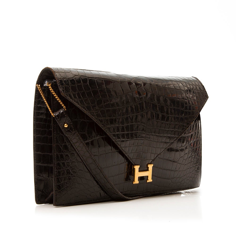 Hermès' penchant for skilfully crafted, simply structured design is perfectly encapsulated in the classic 'Lydie' convertible bag. Constructed in crocodile leather and accented with a gold-tone logo detail at the front flap, this timeless piece can