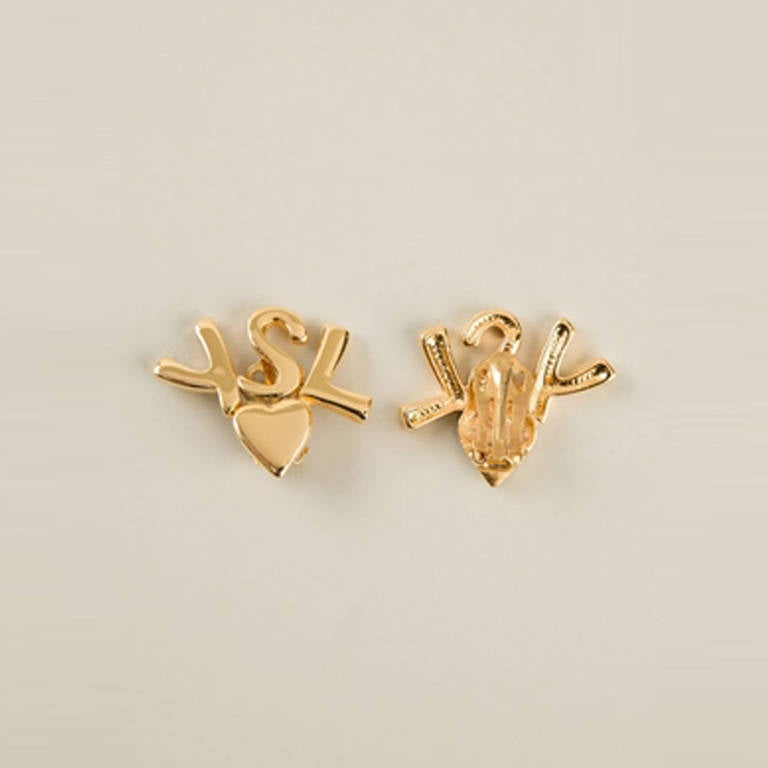 Yves Saint Laurent Vintage Logo Earrings.  	
Super fresh and young, these gold-plated brass logo earrings from Yves Saint Laurent Vintage feature a butterfly fastening and are perfect to work the logomania trend in a subtle way.

Colour: