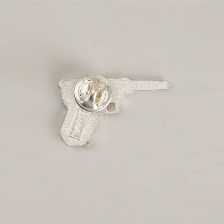 Yves Saint Laurent Vintage Embellished Gun Brooch.  	
Silver-tone metal gun brooch from Yves Saint Laurent Vintage featuring crystal embellishments and a pin fastening.

Colour: Silver

Material: Metal, crystal

Measurements: W: 3.5cm H: